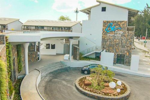a building with a car parked in front of it at Becosy Private Villa Entire Arbnb-Style Stay No Hotel Services in Trou aux Biches