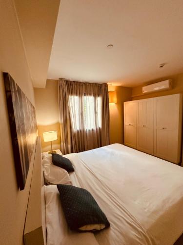 a bedroom with a large white bed and a window at Becosy Private Villa Entire Arbnb-Style Stay No Hotel Services in Trou aux Biches