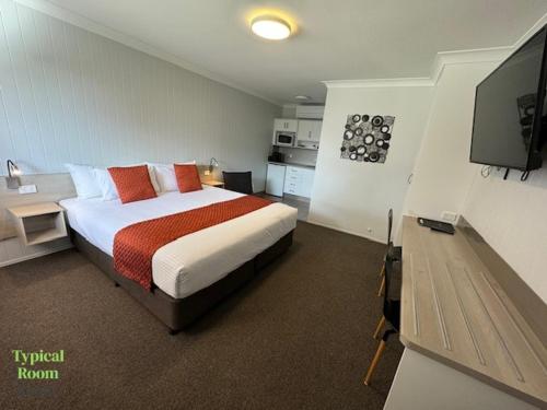 Postel nebo postele na pokoji v ubytování Raintree Motel Biloela