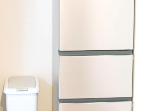 a refrigerator freezer next to a trash can at FOREAT akemanomori in Daisen