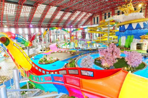 a large indoor water park with a water slide at Da Nang - Mikazuki Japanese Resorts & Spa in Da Nang