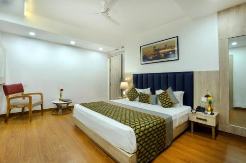 a hotel room with a bed and a chair at OPO Premier, GK2 in New Delhi