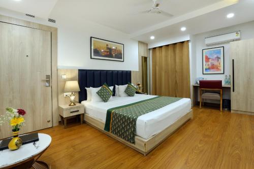 a hotel room with a bed and a desk at OPO Premier, GK2 in New Delhi
