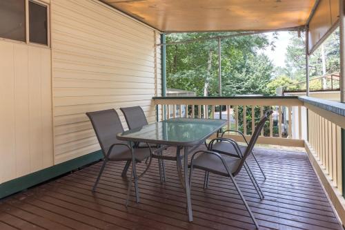 a patio with a table and chairs on a deck at Daylesford Holiday Park in Daylesford