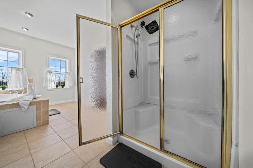 a bathroom with a shower with a glass door at Spacious 6 BR Villa - Serene Scenic Mountain Escape in Bloomingburg