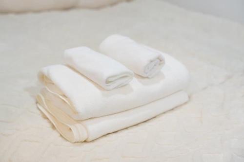 Tres toallas apiladas una encima de otra en el suelo. en 王202整套私人卫浴厨房 洗衣机 车站步行5分钟 上野站地铁直达, en Tokio