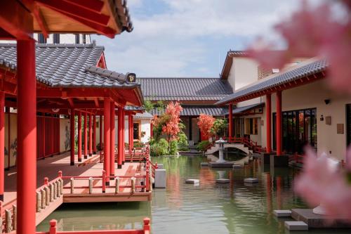 a group of buildings next to a river with a fountain at Da Nang - Mikazuki Japanese Resorts & Spa in Da Nang