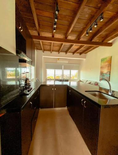 a kitchen with a sink and a counter top at Casa Española del Mar in Cartagena de Indias