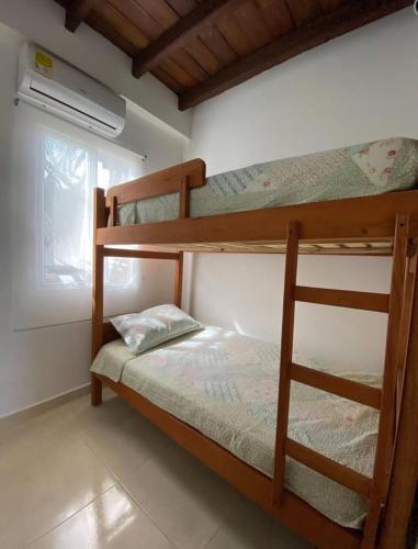 a bedroom with two bunk beds and a window at Casa Española del Mar in Cartagena de Indias