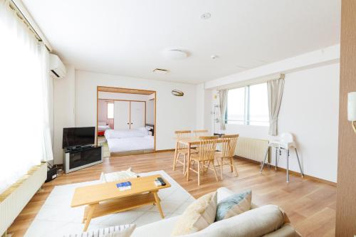 a living room with a couch and a table at STAY IN OTARU in Otaru
