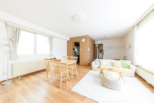 a living room with a table and a couch at STAY IN OTARU in Otaru