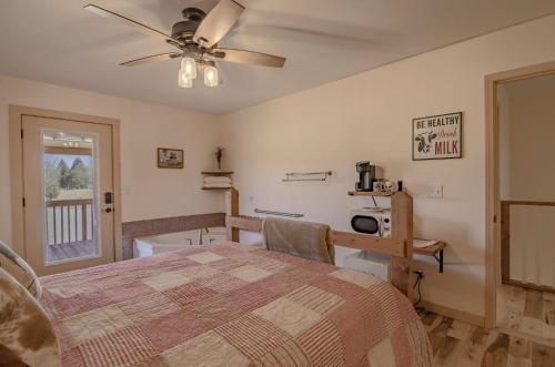 a bedroom with a bed and a ceiling fan at The Inn at Beulah Farm - The Barn in Whitley City