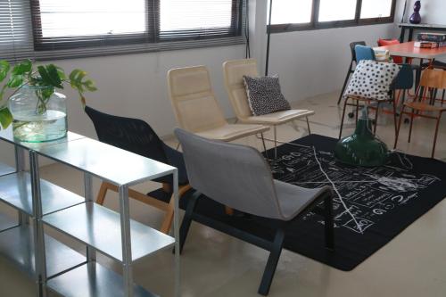 a waiting room with chairs and a table at The Urbanists BKK Entire Floor 4-6 people 4Beds 4Baths near Medpark Hospital , Queen Sirikit Convention hall , Benjakitti Park in Bangkok