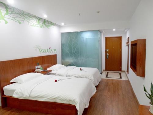 Giường trong phòng chung tại Vatica JiangSu XuZhou XinYi Railway Station Square Hotel