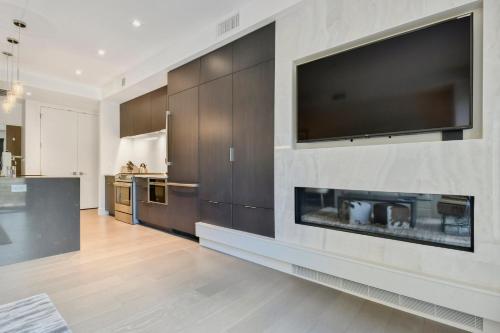 a living room with a fireplace and a television on a wall at Lift Park City Condominiums in Park City