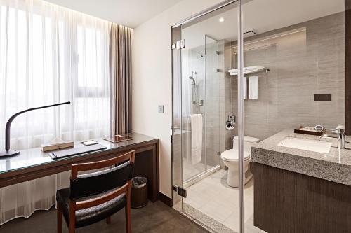 a bathroom with a toilet and a sink and a shower at Hotel Sukimi in Tainan