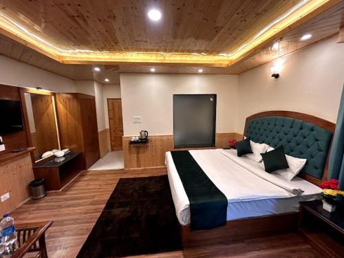 a bedroom with a large bed with a blue headboard at Hidden Heaven Old Manali by velvet loft in Manāli