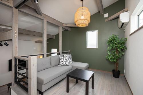 a living room with a couch and a loft bed at Villa Gotemba Fuji in Gotemba