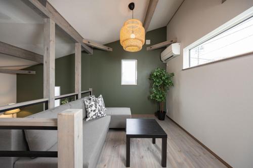 a living room with a couch and a table at Villa Gotemba Fuji in Gotemba