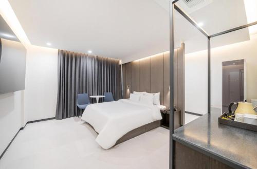 a hotel room with a bed and a mirror at Cheomdan Lantana Hotel in Gwangju