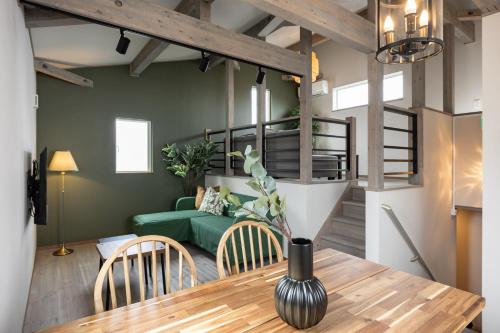 a living room with a table and a bunk bed at Villa Gotemba Fuji in Gotemba