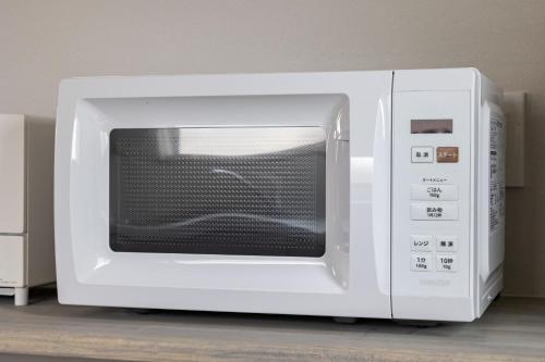 a white microwave oven sitting on top of a counter at Villa Gotemba Fuji in Gotemba