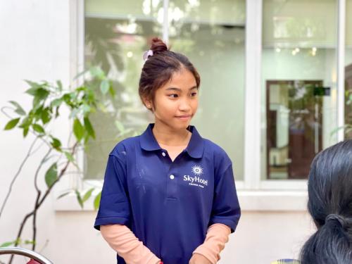 a woman in a blue shirt talking to a customer at SKY VILLA - BKK Phnom Penh - Rooms & Apartments - FREE LAUNDRY in Phnom Penh