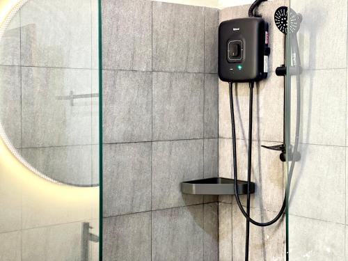 a shower with a camera on the wall of a bathroom at SKY VILLA - BKK Phnom Penh - Rooms & Apartments - FREE LAUNDRY in Phnom Penh