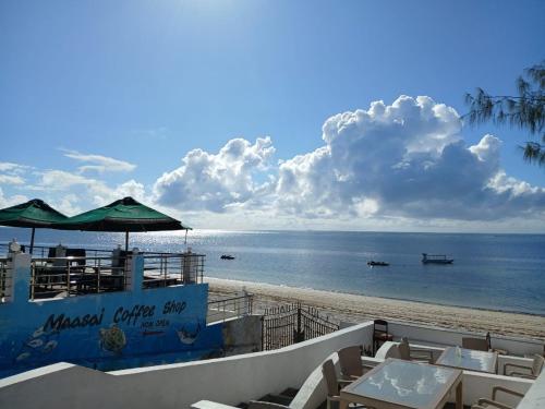 a view of the beach with chairs and umbrellas at The Beach House by Maasai in Mombasa