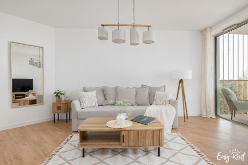 a living room with a couch and a table at Prestige Pinea 610 - basen, sauna, jacuzzi w cenie pobytu - Easy - Rent Apartments in Pobierowo