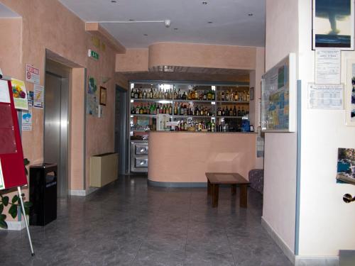 a room with a bar and a counter with alcohol at Hotel Cristallo in Lerici