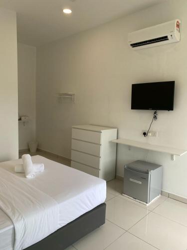 a bedroom with a bed and a flat screen tv at 1108 Pedas Village Resort in Pedas