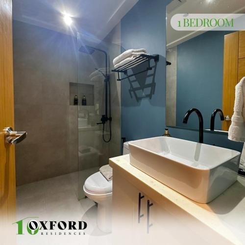 a bathroom with a sink and a toilet at 10 Oxford Residences in Quezon City