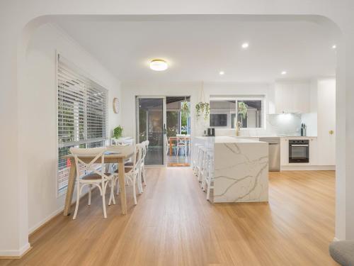 a kitchen and dining room with a table and chairs at Maroochy 4 Bedroom Family Beachhouse in Maroochydore