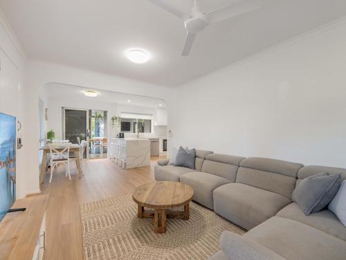 a living room with a couch and a table at Maroochy 4 Bedroom Family Beachhouse in Maroochydore