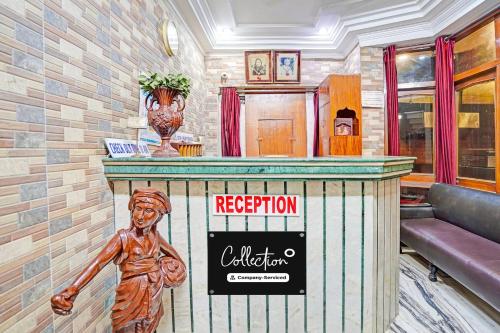 a mural of a statue at a reception counter in a building at Super Collection O Mathura Near Railway Station in Mathura