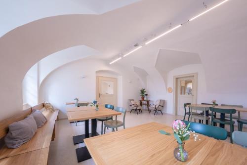 a living room with wooden tables and chairs at Zámek Načeradec in Načeradec