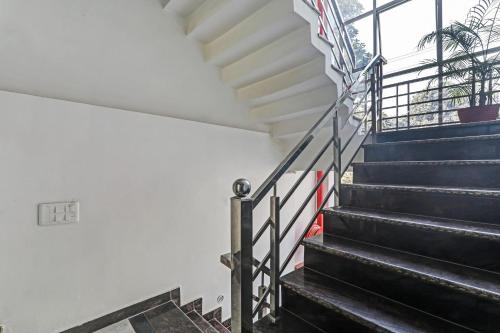 a staircase in a house with blue steps and a window at Collection O Shivashakti Grand Near Chaudhary Charan Singh International Airport in Banthra Sikandarpur