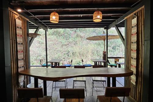 a dining room with a large table and chairs at Mae Mae Home in Ban Tham