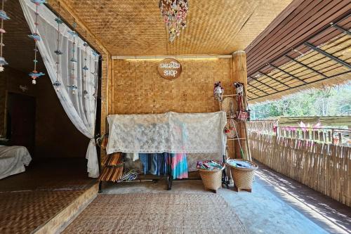 a tent with a table with a blanket and two baskets at Mae Mae Home in Ban Tham