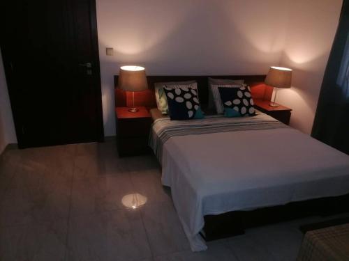 a bedroom with two beds and two lamps at Cool Flat Cidade - Airport in Luanda