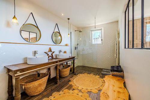 a bathroom with two sinks and a mirror at Mas Gauda in La Gaude