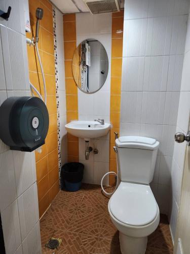 a small bathroom with a toilet and a sink at Khaosan Art Hotel in Bangkok