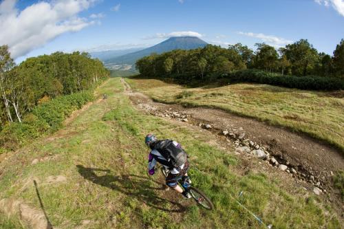 a person riding a bike on a dirt road at Ki Niseko in Kutchan