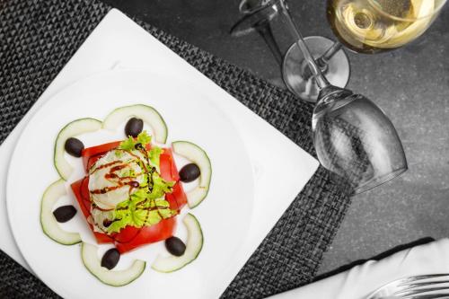 a plate of food with vegetables on a table at Golden Tulip Addis Ababa in Addis Ababa