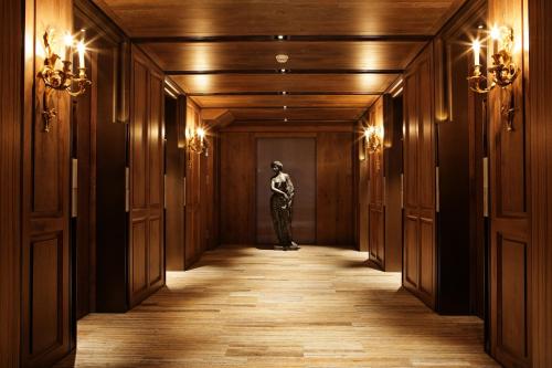 a woman standing in a hallway of a building at Palais de Chine Hotel in Taipei