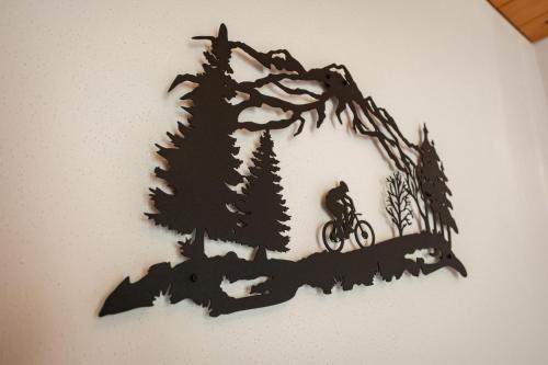 a drawing of a man on a bike on a tree branch at Haus Verena Mittenwald in Mittenwald