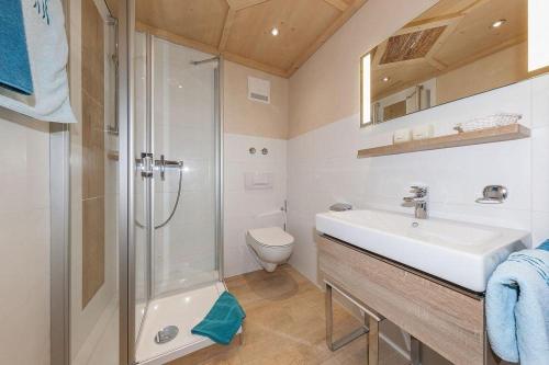 a bathroom with a sink and a shower and a toilet at Haus Verena Mittenwald in Mittenwald