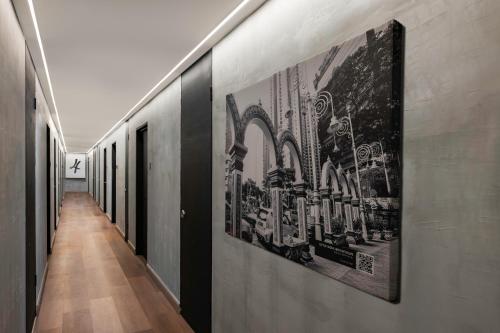 a hallway with black and white posters on the walls at BRYQS Hotel KL Sentral in Kuala Lumpur
