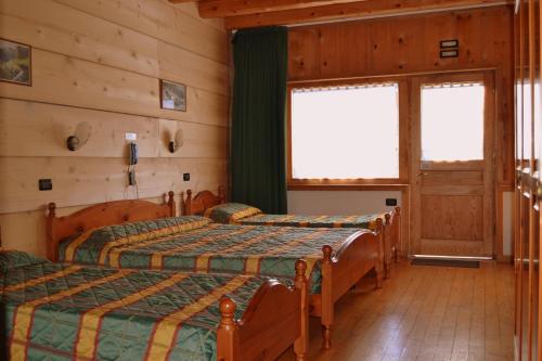 Postel nebo postele na pokoji v ubytování Albergo Rendola